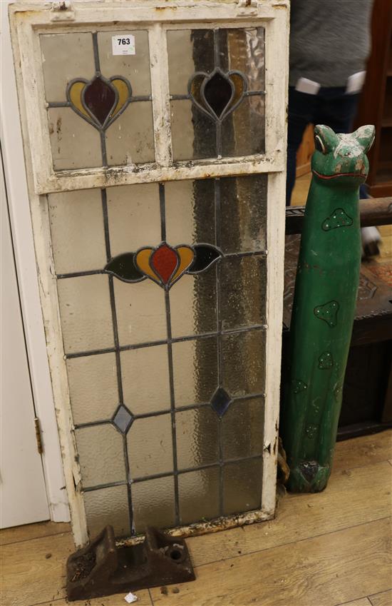 A stained glass window, gypsy folk art frog and railway rivet W.51cm